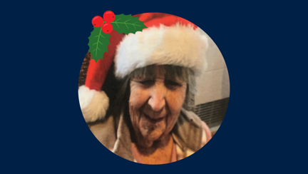 Blind veteran Jean wearing a Christmas hat, detailed with an illustration of holly.