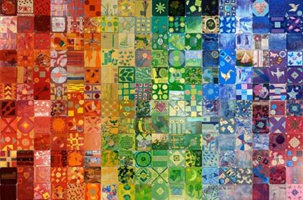 Various colourful designs on small tiles, displayed together to create a rainbow-like collaborative artwork