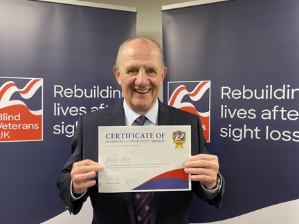 Jules Lee holding his certificate at Founder's Awards 2023
