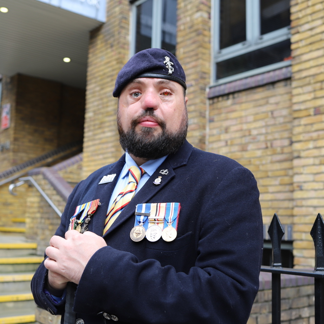 Blind veteran Simon with medals