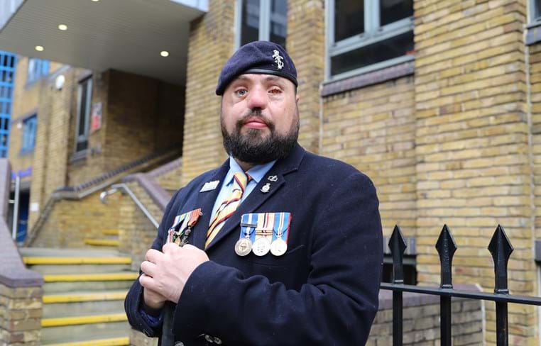 Blind veteran Simon with medals