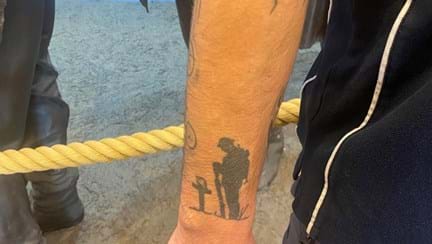 The arm of a member of staff with a tattoo in honour of the fallen