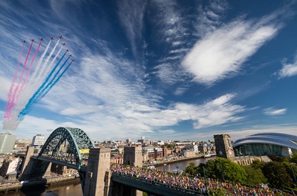 A wide shot of the Red Arrows fly over Tyne Bridge as part of Great North Run 2015