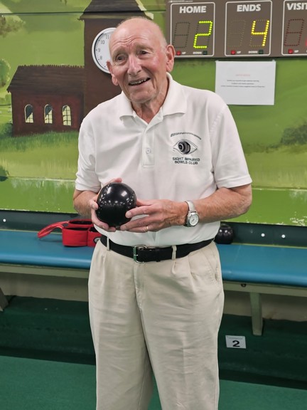 Blind veteran Les holding one of his bowls