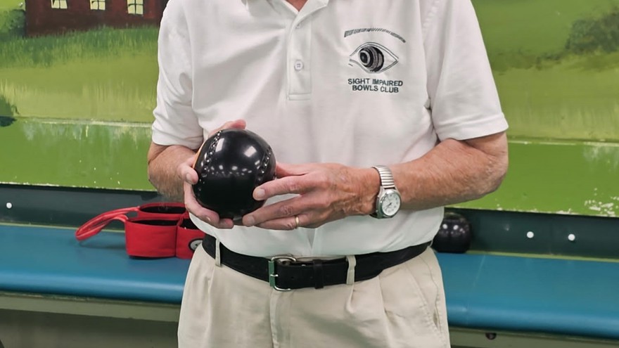 Blind veteran Les holding one of his bowls