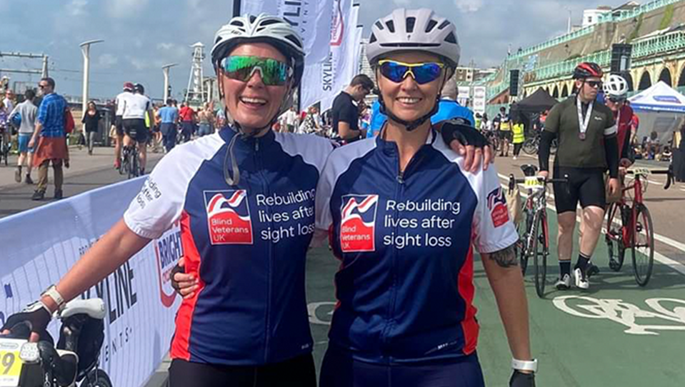 Supporters in branded cycling tops smiling after a cycling marathon 