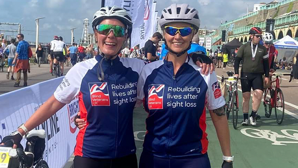 Supporters in branded cycling tops smiling after a cycling marathon 