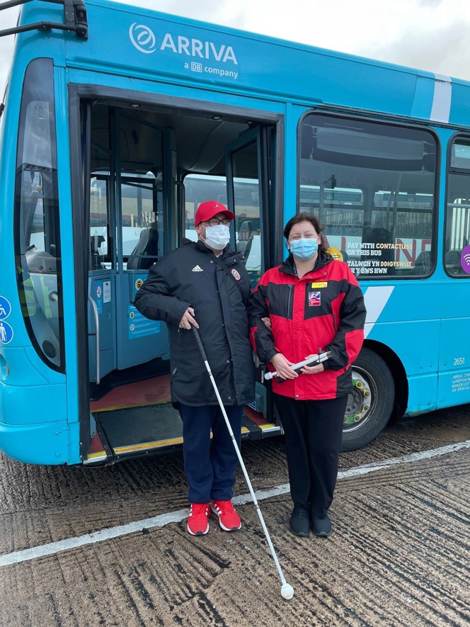 Blind veteran being helped off the bus by one of our Rehabilitation Officers