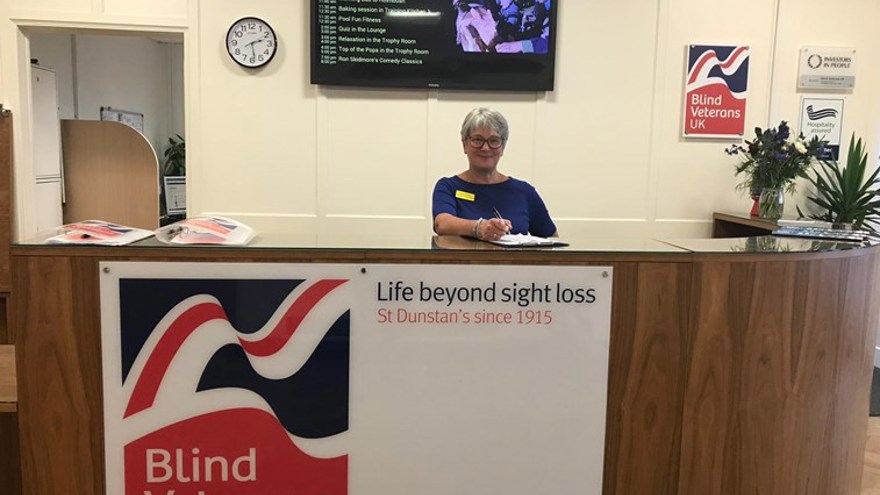 A receptionist smiling at Brighton centre reception