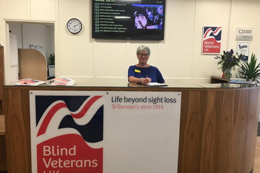 A receptionist smiling at Brighton centre reception