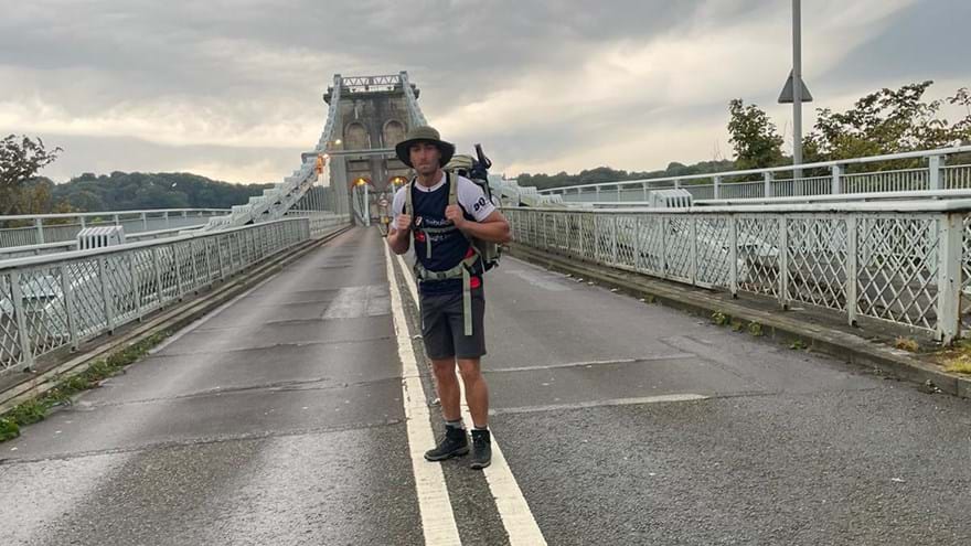 James stood on a bridge wearing his Blind Veterans UK t-shirt