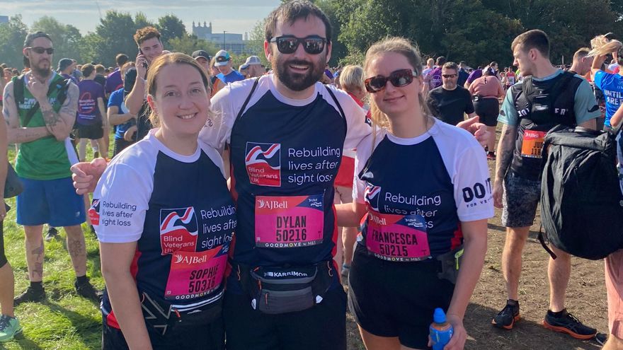 Sophie, Dylan and Francesca with their arms around each other, smiling for the camera ahead of the race.