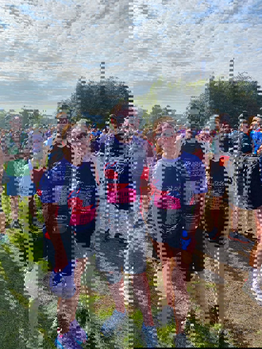 Sophie, Dylan and Francesca with their arms around each other, smiling for the camera ahead of the race.