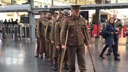 A recreation of our Victory over Blindness statue, showing blind veterans dressed in old military uniforms at Manchester Piccadilly station