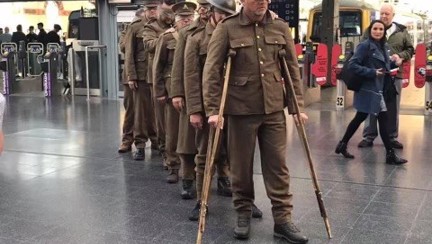 A recreation of our Victory over Blindness statue, showing blind veterans dressed in old military uniforms at Manchester Piccadilly station