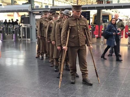 A recreation of our Victory over Blindness statue, showing blind veterans dressed in old military uniforms at Manchester Piccadilly station