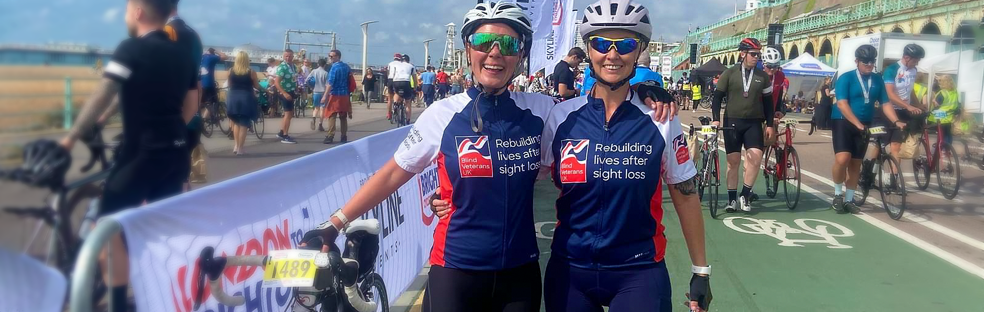 Jo Phipps and partner with a bicycle fundraising for Blind Veterans UK