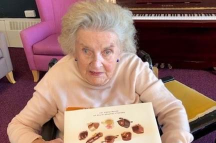 Blind veteran Maureen holding a Thorntons' Classic Collection box of chocolate