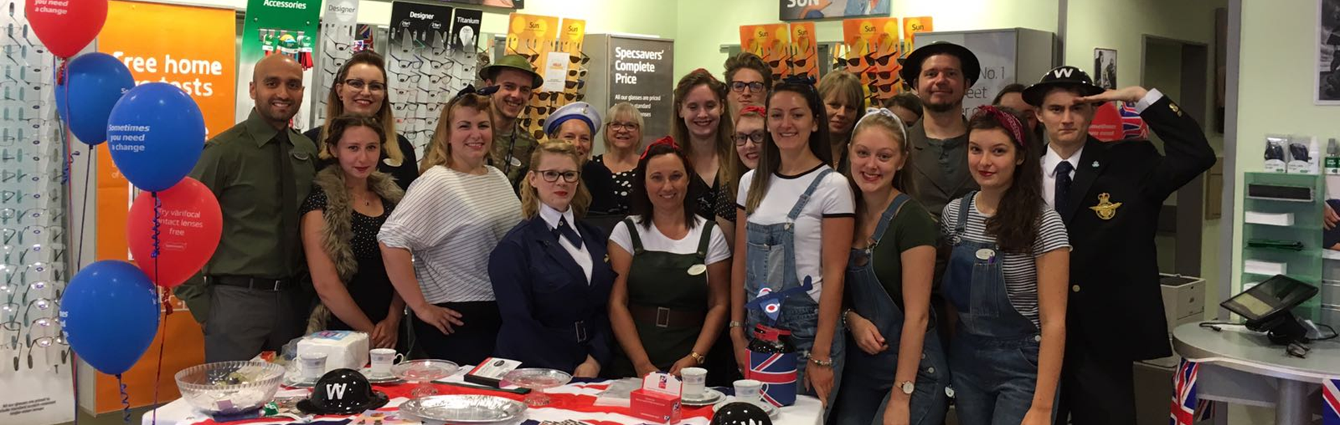  A group of staff members inside Specsavers huddled together wearing military fancy dress while fundraising