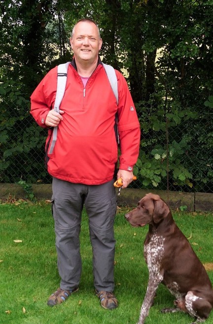 Nigel stopped to pose for a picture during his fundraising walk with his trusty dog sat by his side