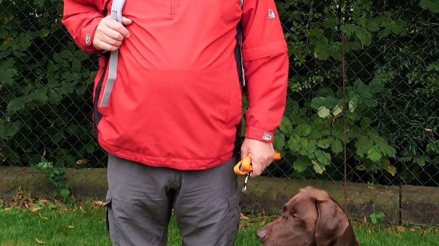 Nigel stopped to pose for a picture during his fundraising walk with his trusty dog sat by his side