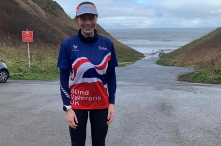 Rachel stood in her Blind Veterans UK T-Shirt with grey sky above