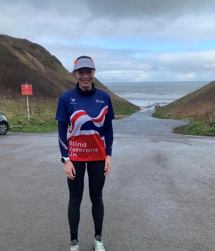 Rachel stood in her Blind Veterans UK T-Shirt with grey sky above