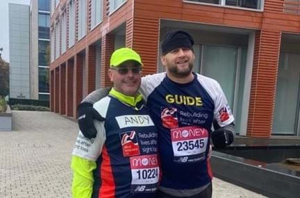 Photo of Andy Leitch (Left) with his guide Wayne Larkin (Right) smiling during the 2020 Brighton Half Marathon