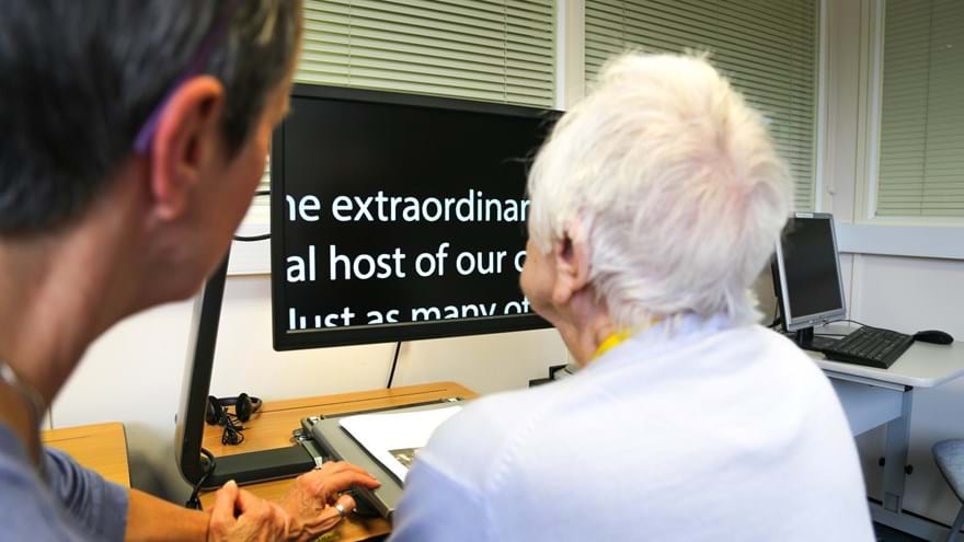 A photo of Janet, Blind veteran, using tech at an Induction week at the Brighton Centre