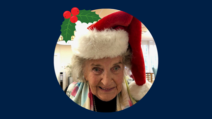 Photo of blind veteran Maureen in Christmas hat