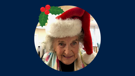 Blind veteran Maureen in a Christmas hat, detailed with an illustration of holly.