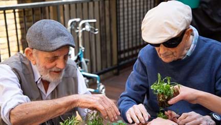 Photo of blind veterans Ken, left, and Richard, right, gardening 