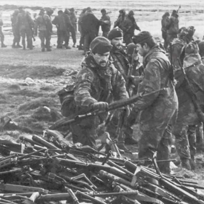 A photo from the Falklands War of British Servicemen collecting guns from surrendering Argentinians in June 1982