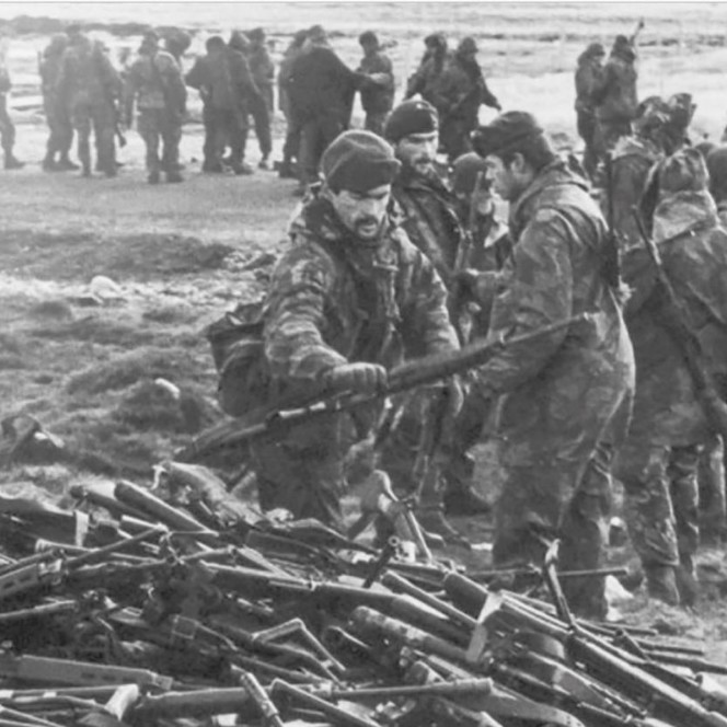 British soldiers at the end of the Falklands War, placing surrendered guns in a pile