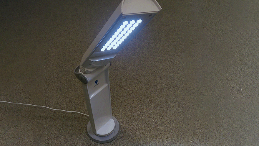 A small LED reading light on a desk