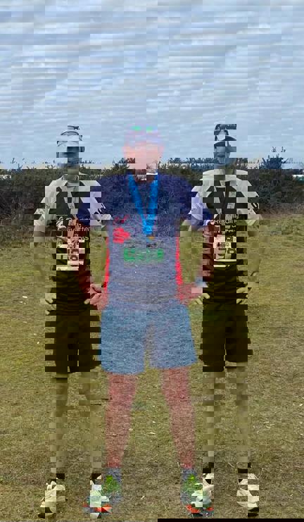 Picture of Andrew wearing his Blind Veterans UK running top