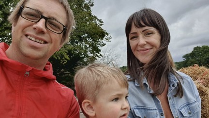 The family are outside, Stephanie and Kieran look into camera, Lennon looks away