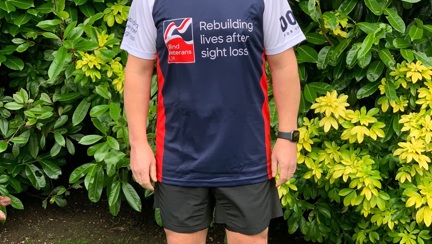 Veteran Justin, in running gear and a Blind Veterans UK top