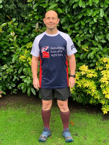 Veteran Justin, in running gear and a Blind Veterans UK top