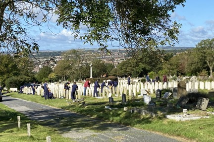 Several volunteers pictured cleaning and restoring graves at Brighton Cemetery