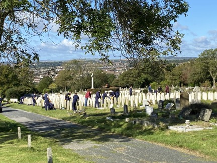 Several volunteers pictured cleaning and restoring graves at Brighton Cemetery