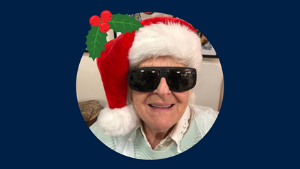 Photo of blind veteran, Betty, in Christmas hat
