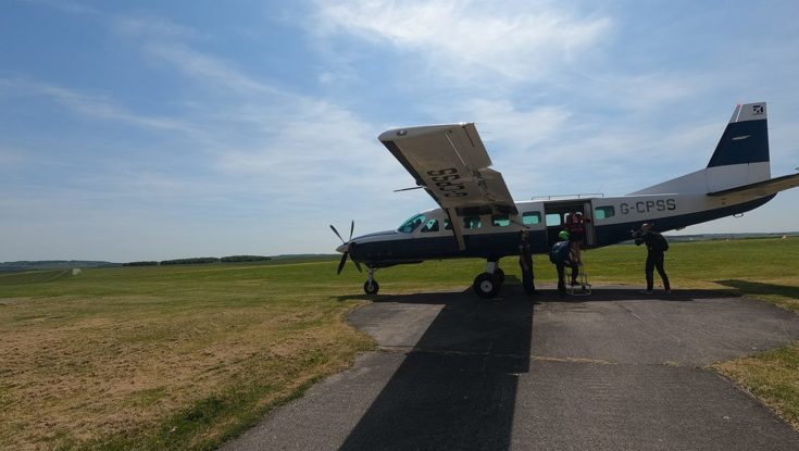 Mark being guided onto the plane by his tandem instructor