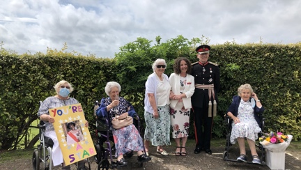 Photo of Blanche, Residential Care Manager with some of our veterans