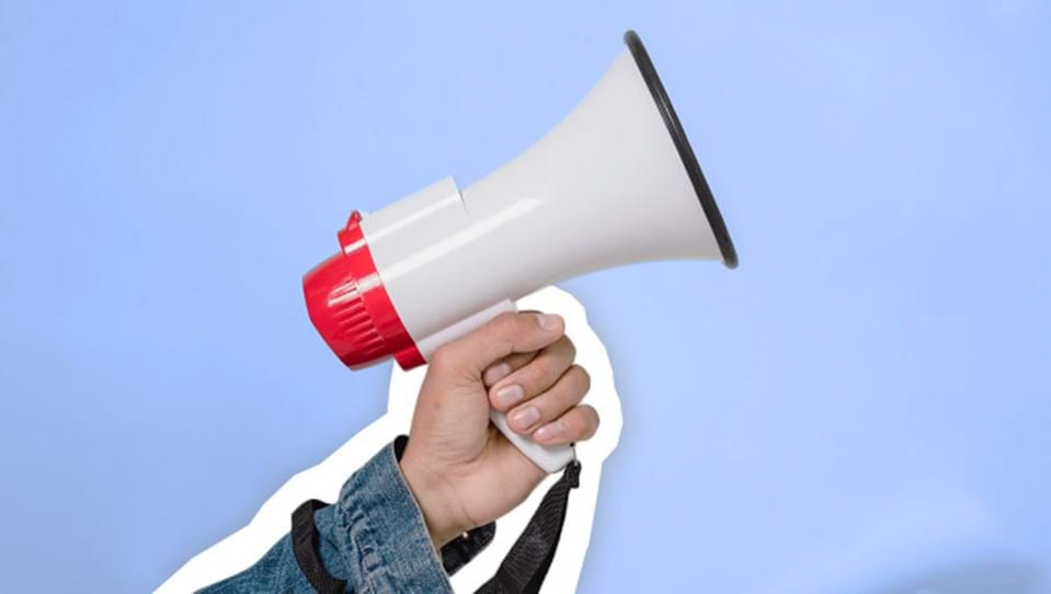 A photo of a hand holding a megaphone