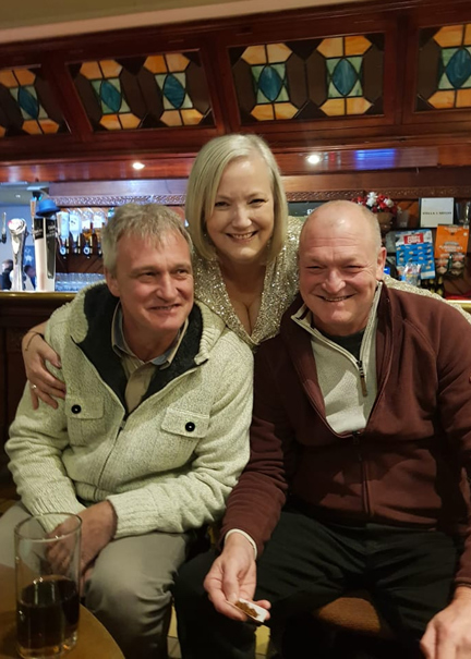 Christine stood between her two brothers and all three are smiling widely