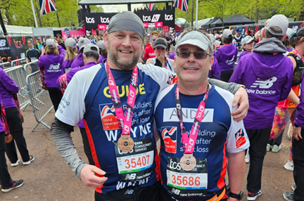 Andy and Wayne wearing Blind Veterans UK t-shirts with their London Marathon medals around their necks