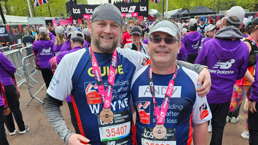Andy and Wayne wearing Blind Veterans UK t-shirts with their London Marathon medals around their necks