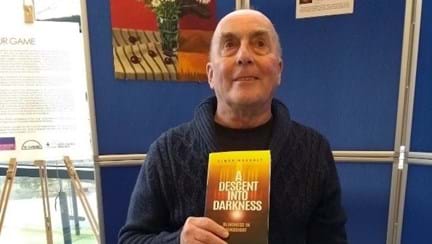 Photo of blind veteran, Simon, at the launch of his first book, Descent Into Darkness, Blindness in Hindsight