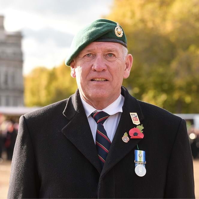 Blind veteran Steve wearing his beret, poppy and military badge at Remembrance event